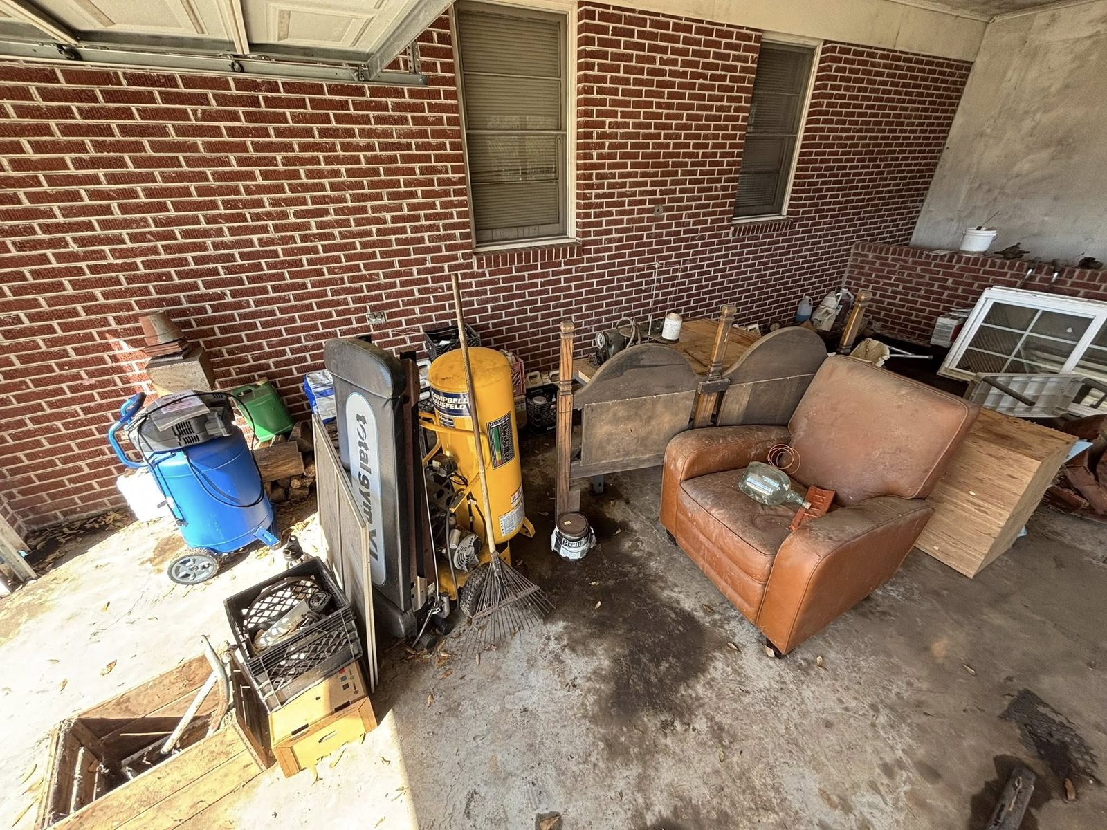 Covered porch full of junk and furniture