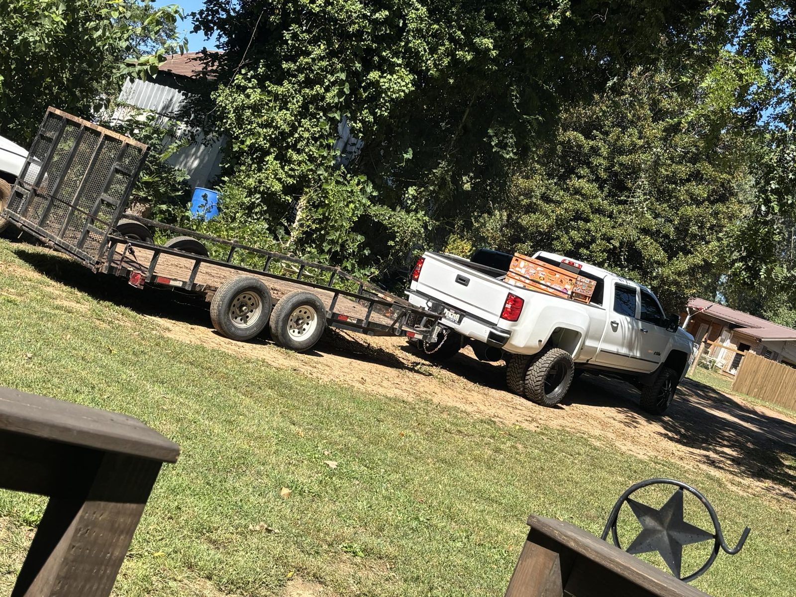 White truck towing trailer leaving job site