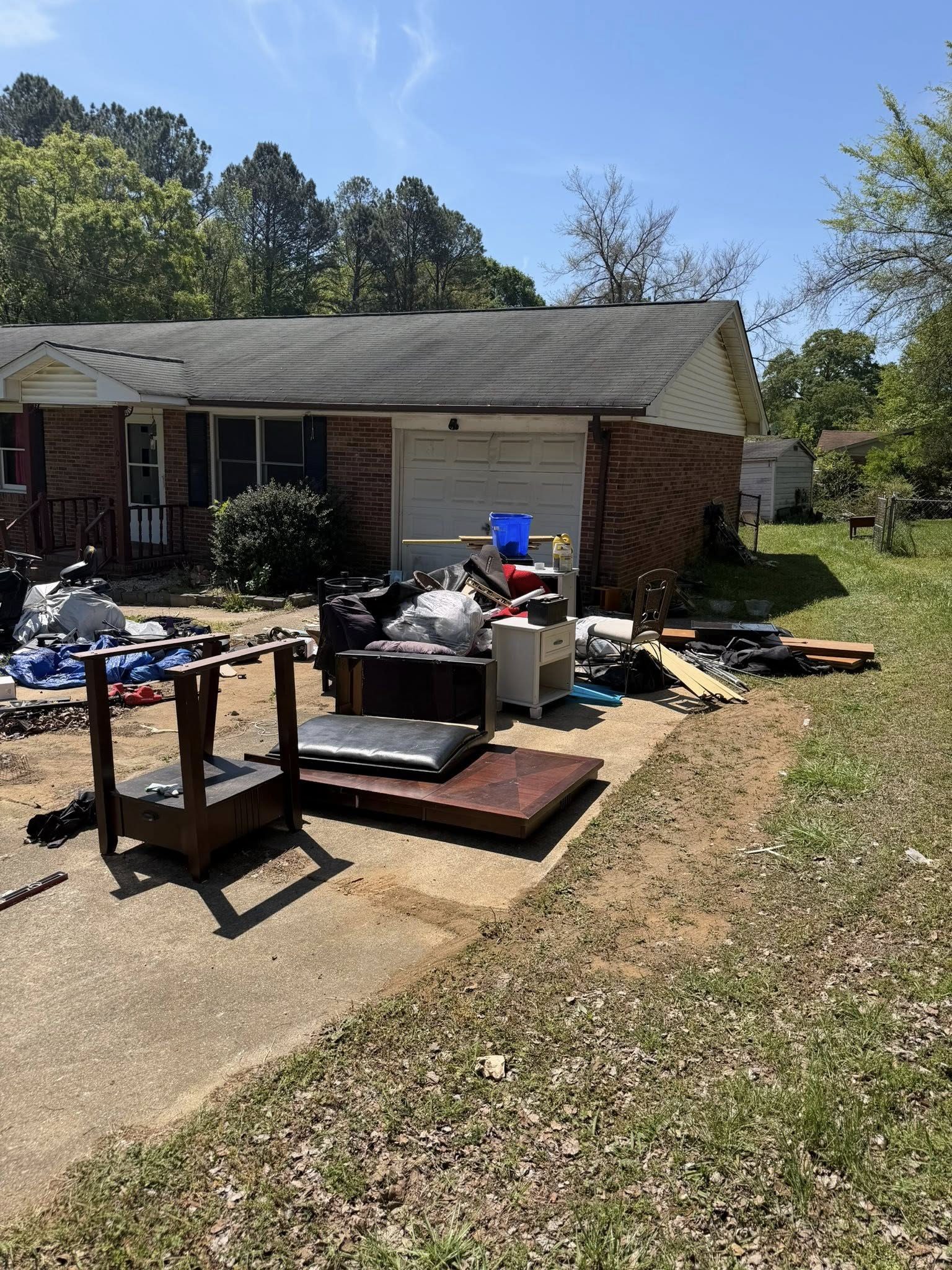 House cleanout with junk pile on driveway