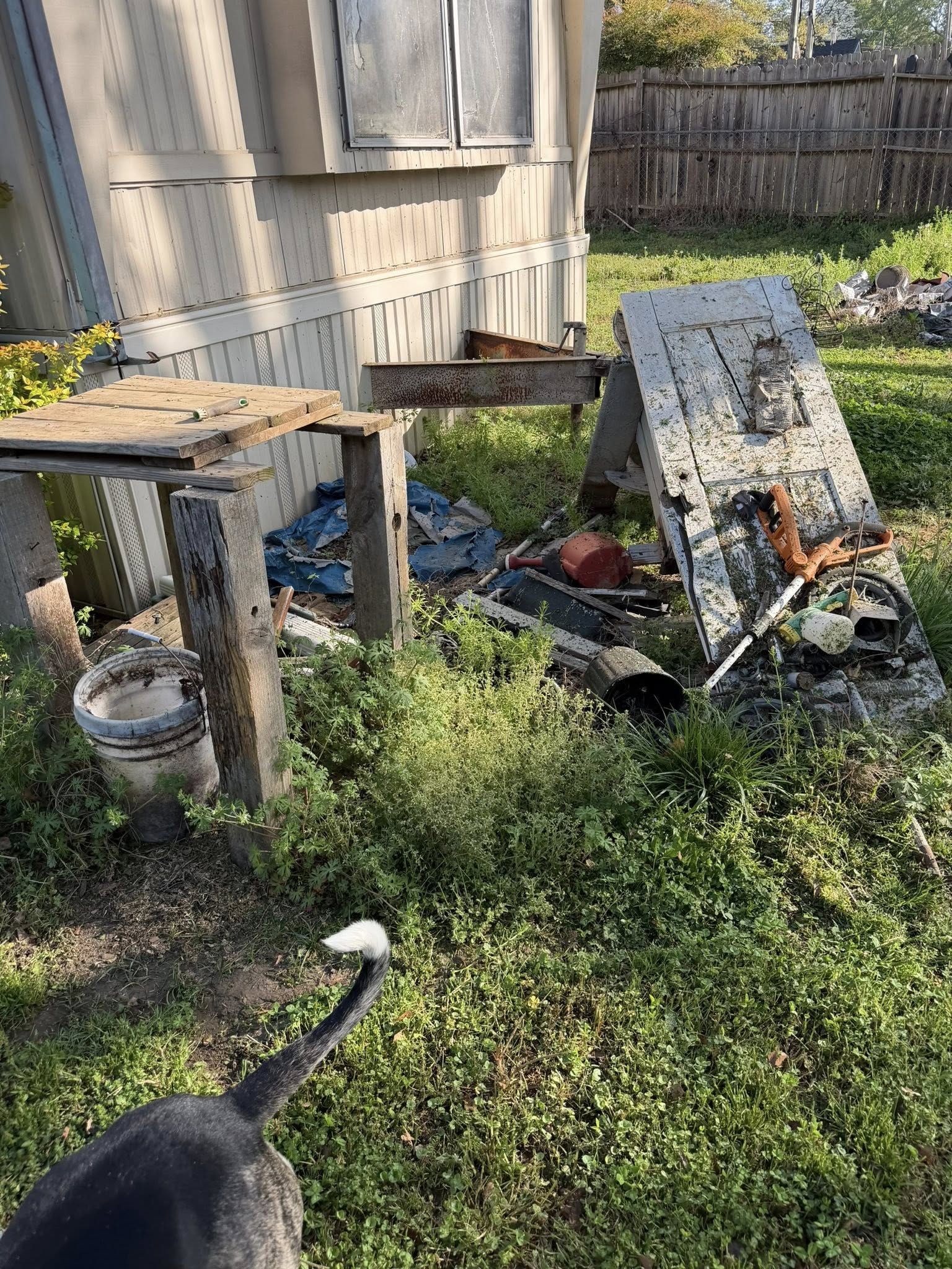 Yard junk and debris beside mobile home