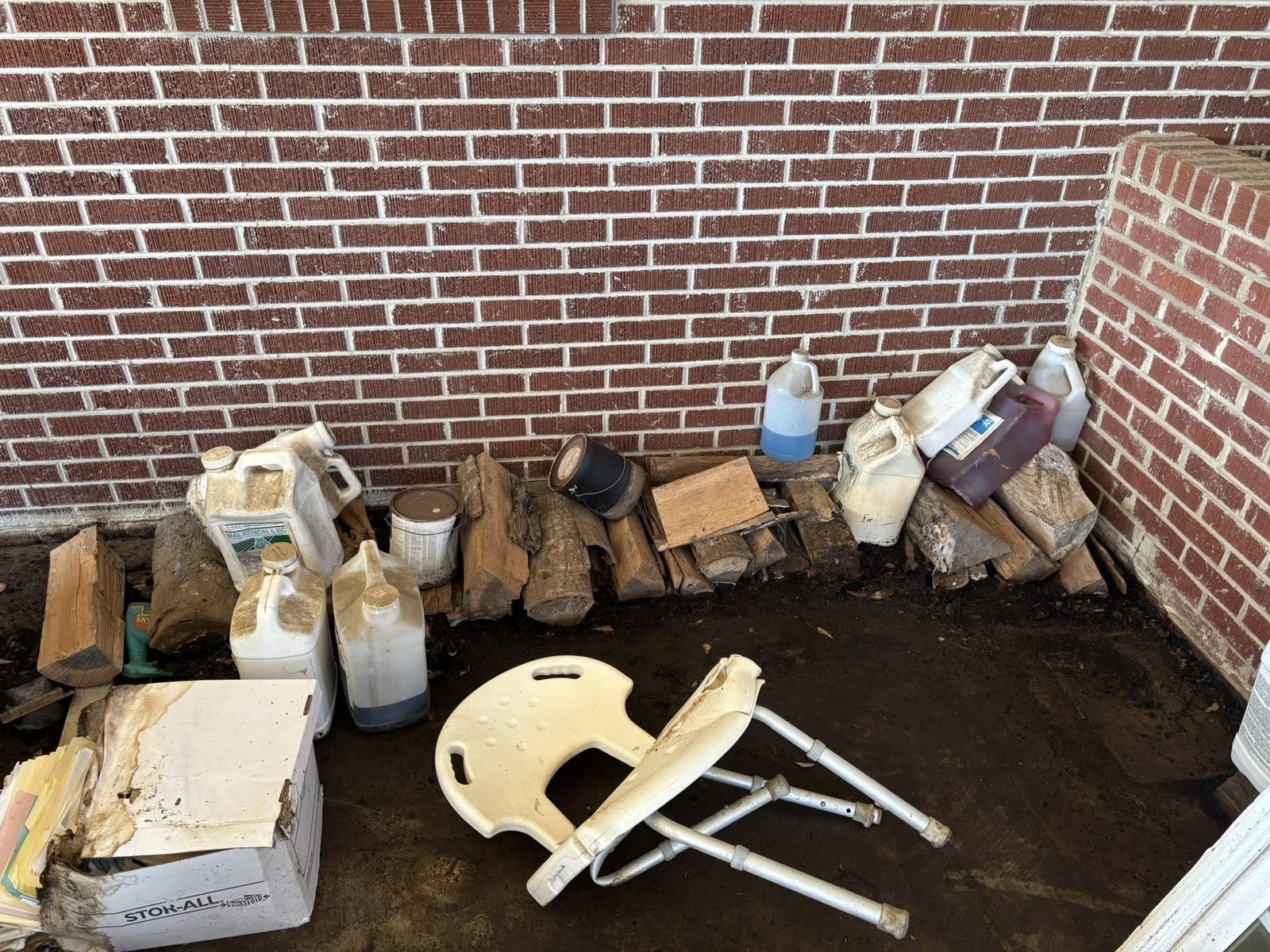 Backyard junk pile with logs and containers